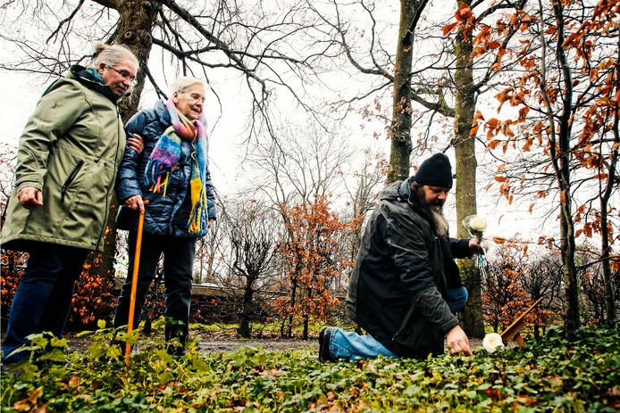 Moeder To Hammann en haar zoon en schoondochter leggen na 56 jaar bloemen bij het graf van Dominique.
